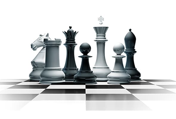 Chess pieces on a mirrored board representing strategic positioning
